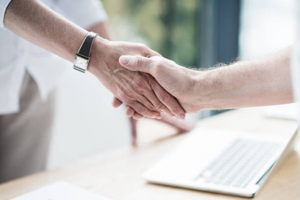 istock Business partners shaking hands at office 696593320