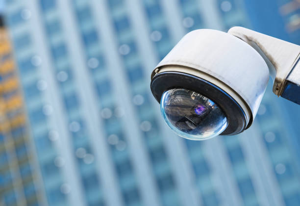 istock cctv security camera in a city with blury business building on background 696593416