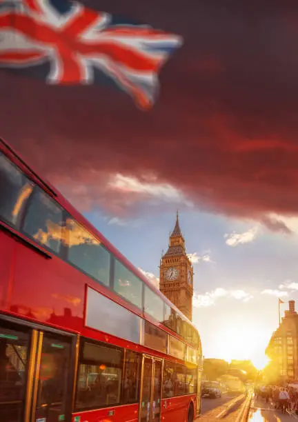 Photo of Double decker bus against Big Ben with colorful sunset in London, England, UK