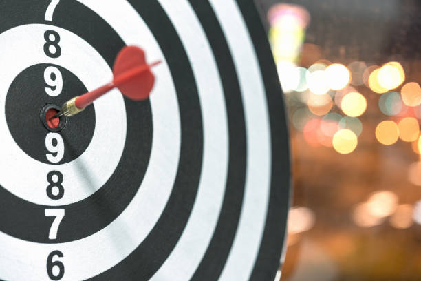 istock Dart target arrow hitting on bullseye with bokeh background 696601836