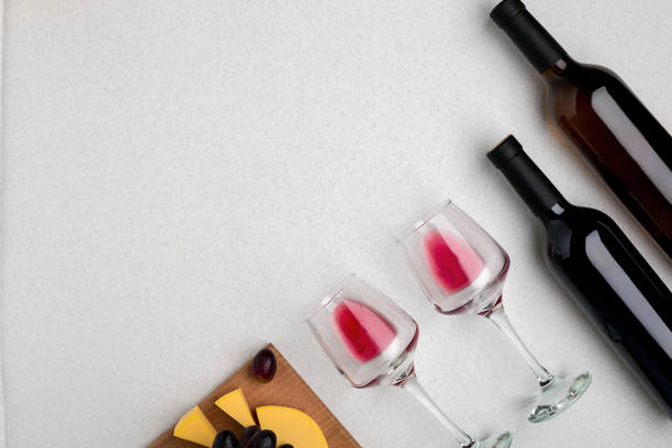 istock Two glasses of red wine, cheese and grapes. Top view 696604964