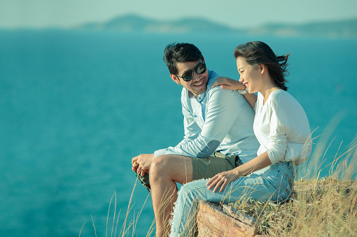 portrait of asian younger man and woman relaxing vacation at sea side happiness emotion