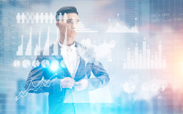 istock Pensive Asian businessman in a city with graphs 696612440