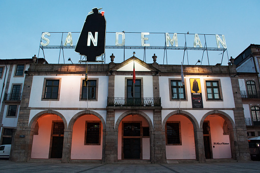 Vila Nova de Gaia, Portugal - March, 27, 2012: view of the iconic Casa Sandeman, the House of Sandeman, an 1811 granite building overlooking Porto and the Douro River and housing the Museum and the cellars with Porto and Sherry wines