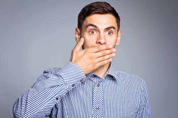 istock Surprised face of business man on gray background 696612794