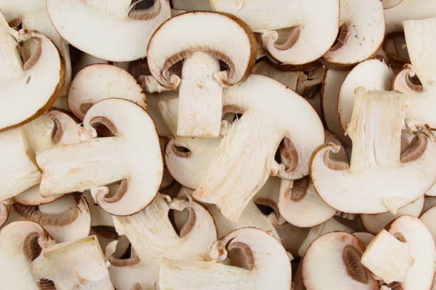 istock fresh mushroom slices food background texture 696613726
