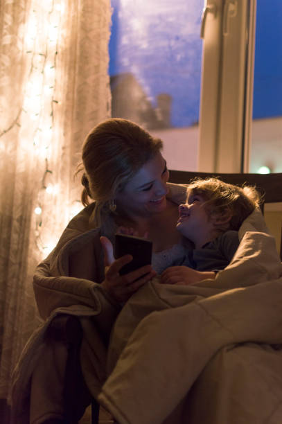istock Mother and son looking at mobile phone 696614020