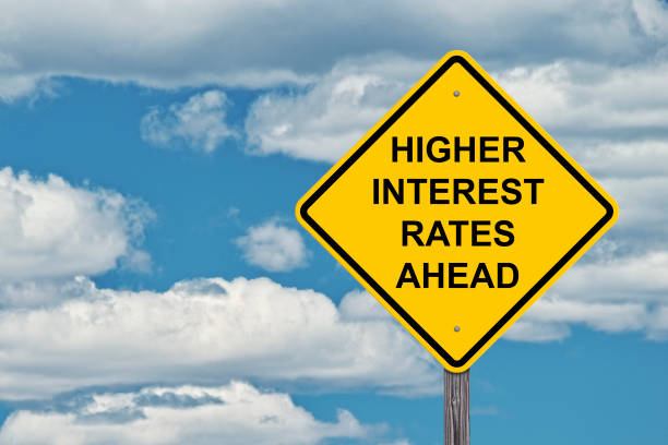 istock Caution Sign Blue Sky Background - Higher Interest Rates Ahead 696614132