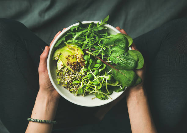 istock Breakfast with spinach, arugula, avocado, seeds and sprouts in bowl 696614682