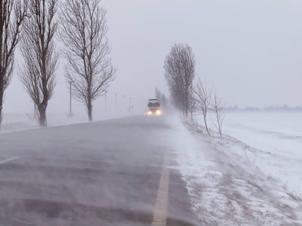 istock Road under the blizzard, snowstorm 696615170