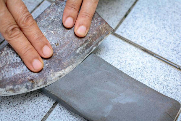 istock close up hand with Knife sharpener on rock 696615320