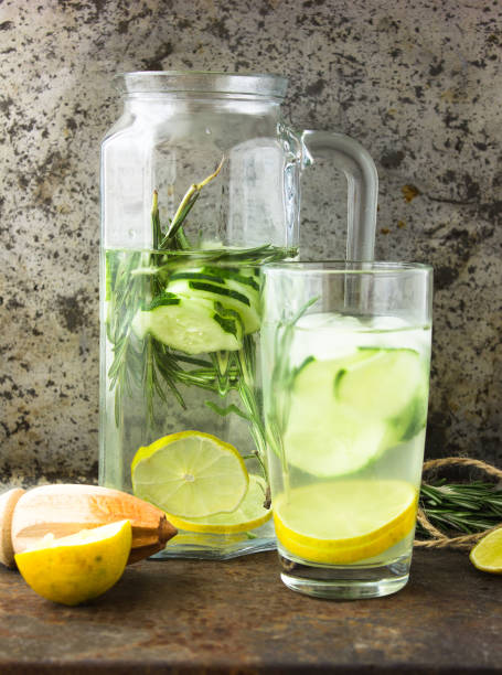 istock Glasses with fresh organic detox cucumber water on gray surface 696620834