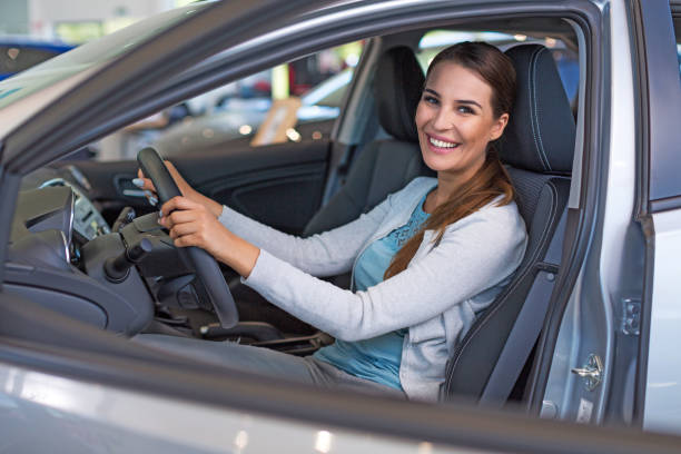 istock Happy young woman with her new car 696626892