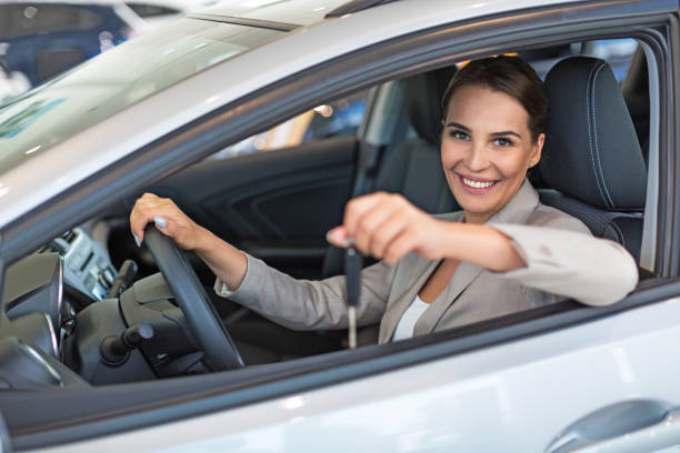 istock Happy young woman with her new car 696627092