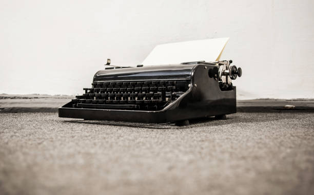 istock Old typerwiter with cyrillic letters on grey floor background 696628160