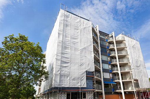 Scaffolding with safety nets during renovation of an apartment building in the Netherlands