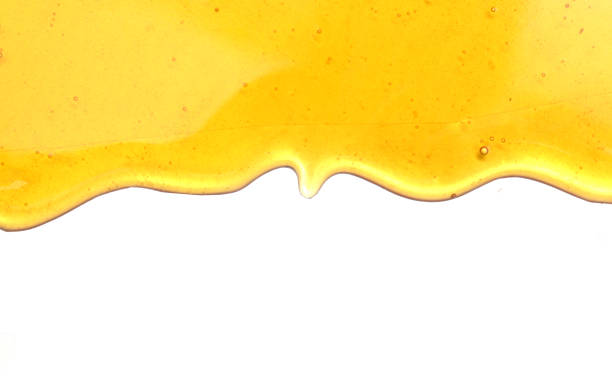 miele dolce isolato su sfondo bianco - honey abstract photography composition foto e immagini stock