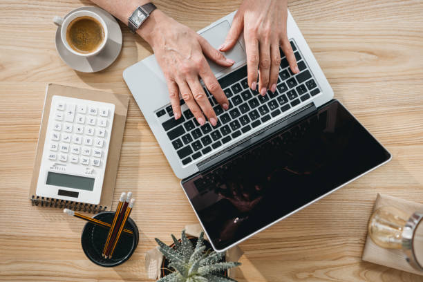 istock Senior business woman working on laptop computer in office 696639654