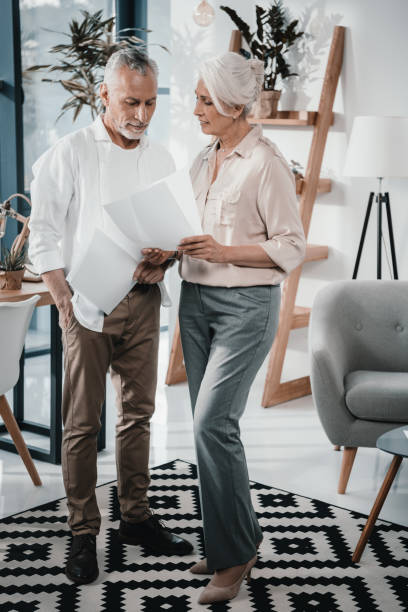istock Senior business colleagues converse at office 696642966