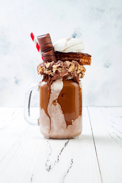 istock Chocolate indulgent exreme milkshake with brownie cake, marshmallow and sweets. Crazy freakshake food trend. Copy space 696651164