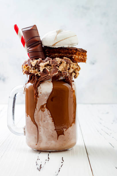istock Chocolate indulgent exreme milkshake with brownie cake, marshmallow and sweets. Crazy freakshake food trend. Copy space 696651226