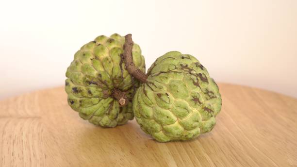 istock Sugar Apple custard apple, Annona, sweetsop on wooden table 696657846