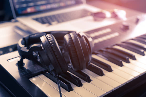 istock Black headphone on home Music studio keyboard 696658500