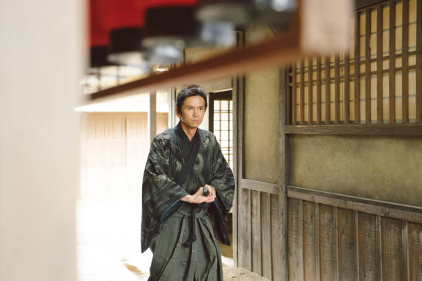 istock Samurai warrior walking through a traditional Japanese village 696662144