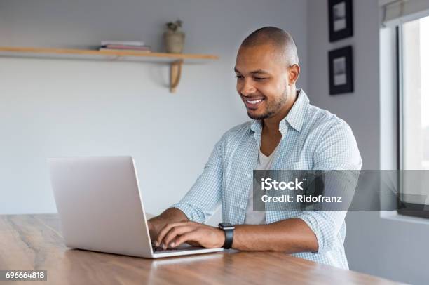 Man Working On Laptop At Home Stock Photo - Download Image Now - Men, Laptop, Using Computer