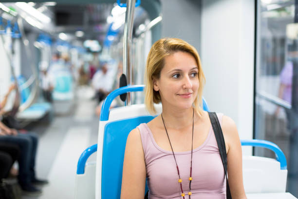 istock Happy woman travelling public transportation 696665762