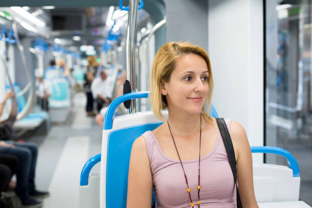 istock Happy woman travelling public transportation 696665830