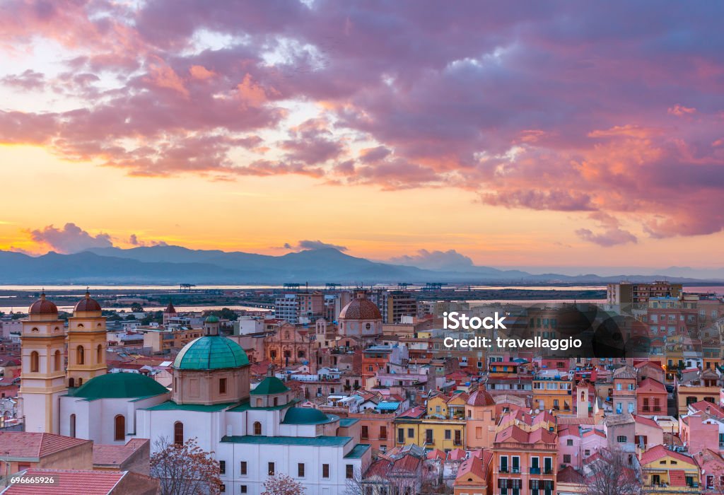 Sunset on Cagliari, evening panorama of the old city center in Sardinia Capital, view on The Old Cathedral and colored houses in traditional style, Italy Sunset on Cagliari, evening panorama of the old city center in Sardinia Capital, view on The Old Cathedral and colored houses in traditional style, Italy. Cagliari Stock Photo