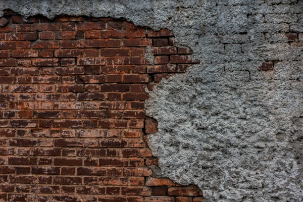 istock The old brick and stone wall with plaster 696694412