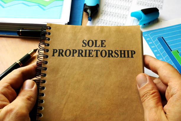 istock Hands holding book with title Sole proprietorship. 696697608