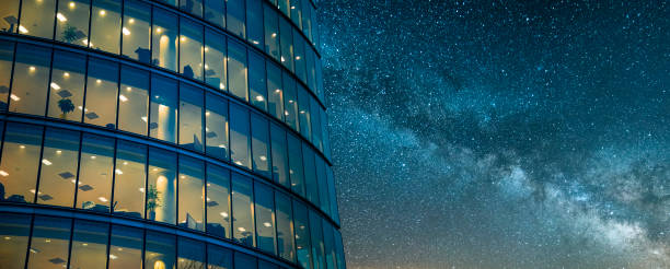 Office building at night A beautiful office building at night. The building is part of a large group of office buildings situated near London's city hall building, United Kingdom. center of the universe stock pictures, royalty-free photos & images