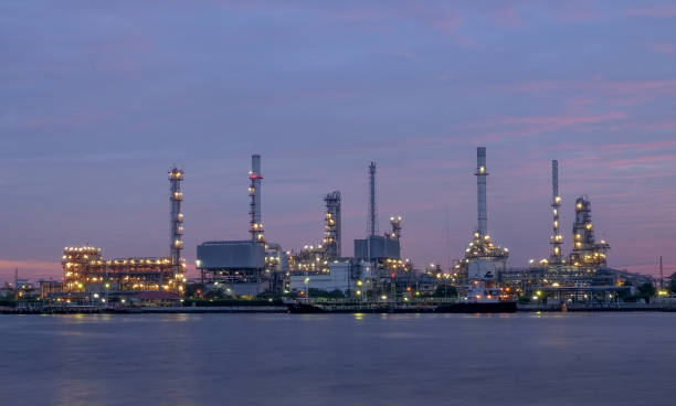 istock river side oil refinery industry plant along twilight morning 696700590
