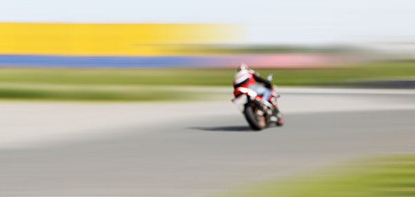 Abstract blurred background with copyspace. Blur motion of motorcycle racer on a track.