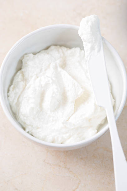istock Fresh ricotta cheese in white bowl 696704034