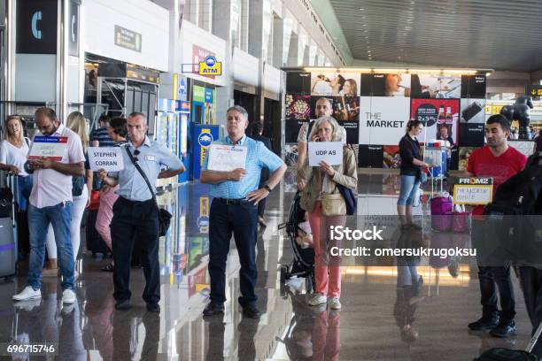 People Expect The Arriving Passengers At The Exit In Barcelona Airport Stock Photo - Download Image Now