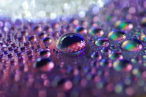 Photo of Macro Water drops DVD multicolor surface, defocused, bokeh, blur