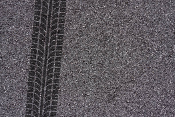 istock tire track on asphalt 696719240