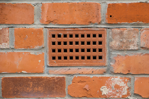 brick wall with a close up showing a ventilation brick