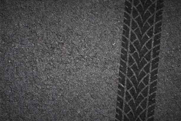 tire tread pattern on asphalt background