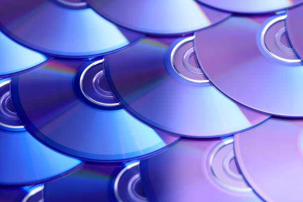 compact discs background. several cd dvd blu-ray discs. optical recordable or rewritable digital data storage. - blu ray disc imagens e fotografias de stock