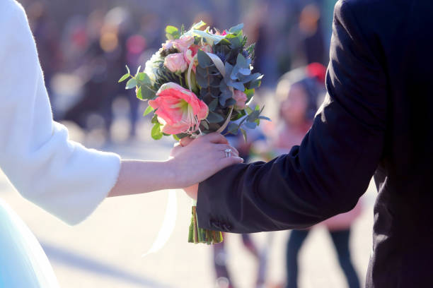 istock the bride and groom holding wedding bouquet 696734006