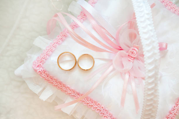 istock gold wedding rings on a pillow 696737878