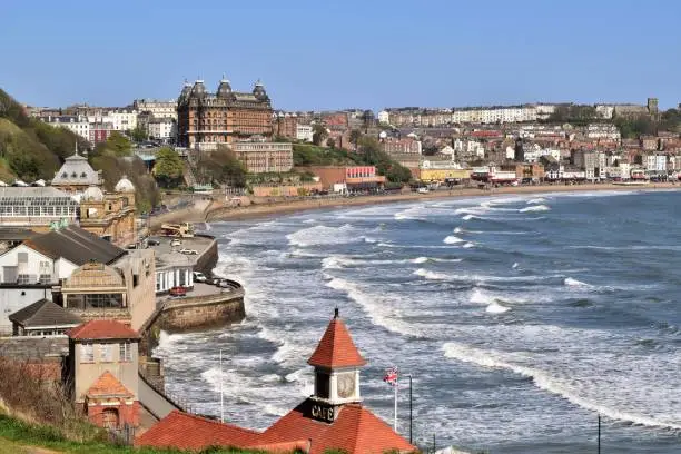 View of Scarborough's south bay, taken from the Esplanade on a sunny, spring day. The sea is choppy and the sky is a clear blue.