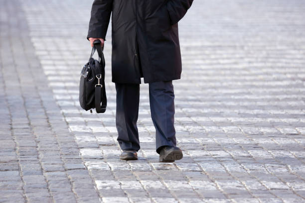 istock business man walks on a pedestrian crossing 696741610