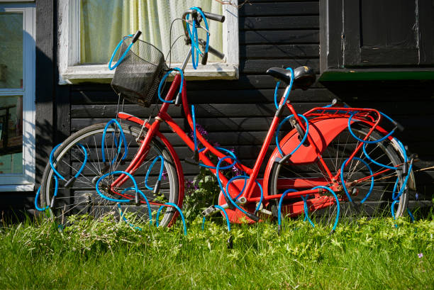 Safe bike Bike is locked garden / back garden - the bicycle is locked with several bicycle locks. Super safe locked bike pedal bin stock pictures, royalty-free photos & images