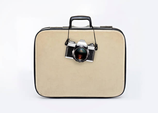 istock camera hanging from a retro luggage 696748910